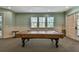 Spacious billiard room with a pool table, windows, and neutral decor at 5401 Bentgrass Dr # 1-302, Sarasota, FL 34235