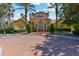 Stunning clubhouse showcasing well-maintained landscaping, and vibrant architecture against a clear blue sky at 5401 Bentgrass Dr # 1-302, Sarasota, FL 34235