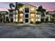 Charming condo building with colorful facade, beautiful landscaping, and bright, airy hallways at 5401 Bentgrass Dr # 1-302, Sarasota, FL 34235