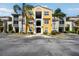 Charming condo building with colorful facade, beautiful landscaping, and bright, airy hallways at 5401 Bentgrass Dr # 1-302, Sarasota, FL 34235