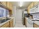 Functional kitchen with updated appliances, generous counter space, and natural wood cabinets at 5401 Bentgrass Dr # 1-302, Sarasota, FL 34235