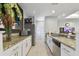 Well-equipped kitchenette featuring granite countertops, stainless steel appliances, and ample cabinet space at 5401 Bentgrass Dr # 1-302, Sarasota, FL 34235