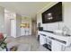 Comfortable living room featuring updated flooring and modern furniture with pass through to kitchen at 5401 Bentgrass Dr # 1-302, Sarasota, FL 34235