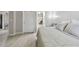 Bedroom featuring ensuite bathroom, neutral tones, and stylish decor at 5401 Bentgrass Dr # 1-302, Sarasota, FL 34235