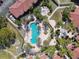 Overhead shot showcases the stylish kidney-shaped pool and hot tub surrounded by palm trees and lounge chairs at 5401 Bentgrass Dr # 1-302, Sarasota, FL 34235