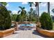 Beautiful tiered water fountain surrounded by manicured landscaping and a brick walkway in a community setting at 5401 Bentgrass Dr # 1-302, Sarasota, FL 34235