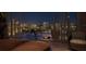 Balcony with elegant dining and a view overlooking city lights at 550 Golden Gate Point # 201, Sarasota, FL 34236