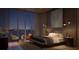 Serene main bedroom at night with water views, soft lighting, and elegant decor at 550 Golden Gate Point # 201, Sarasota, FL 34236