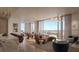 Bright living room with modern furnishings and a balcony overlooking the city at 550 Golden Gate Point # 201, Sarasota, FL 34236