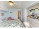 Comfortable bedroom with floral bedding, built-in storage, and a view into the kitchen at 5619 Bayshore Rd # 107, Palmetto, FL 34221