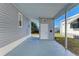 Exterior of the property featuring a covered patio area and access to the backyard at 5619 Bayshore Rd # 107, Palmetto, FL 34221