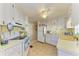Bright kitchen with white cabinetry, appliances, and ample counter space at 5619 Bayshore Rd # 107, Palmetto, FL 34221