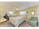 Spacious main bedroom features a canopy bed, soft natural light, and a cozy sitting area at 5619 Bayshore Rd # 107, Palmetto, FL 34221