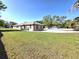 Expansive backyard featuring a well-maintained lawn and a view of the home's exterior at 5714 38Th E Ave, Bradenton, FL 34208