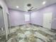 Spacious bedroom featuring neutral walls, tile floors, and a ceiling fan at 5714 38Th E Ave, Bradenton, FL 34208