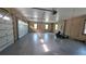 A spacious two car garage with plenty of natural light provided by two windows and an electric door at 5714 38Th E Ave, Bradenton, FL 34208