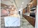 Open-concept kitchen with waterfall countertop island and stainless steel appliances at 5714 38Th E Ave, Bradenton, FL 34208