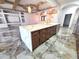 Beautiful kitchen island with dark cabinets and a waterfall countertop at 5714 38Th E Ave, Bradenton, FL 34208