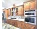 Modern kitchen with stainless steel appliances, custom cabinets, and granite countertops at 5714 38Th E Ave, Bradenton, FL 34208