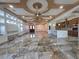 Expansive living room with elegant marble floors, tray ceilings, and an open layout at 5714 38Th E Ave, Bradenton, FL 34208