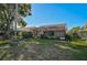 Well-maintained backyard featuring a screened-in lanai and lush landscaping, perfect for outdoor relaxation and entertainment at 6017 Marella Dr, Sarasota, FL 34243