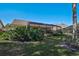 Backyard and patio area showcasing the landscaping with palm trees and a view of the outdoor space at 6017 Marella Dr, Sarasota, FL 34243