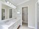 Bathroom featuring double sink vanity, large mirror, and walk-in shower at 6017 Marella Dr, Sarasota, FL 34243