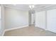 Neutral bedroom with white trim, light wood flooring, and access to closets at 6017 Marella Dr, Sarasota, FL 34243