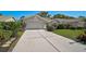 Inviting one-story home features a well-manicured lawn and lush landscaping, enhancing curb appeal at 6017 Marella Dr, Sarasota, FL 34243