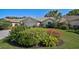 Beautiful home with a well-manicured lawn and vibrant flower beds adding pops of color at 6017 Marella Dr, Sarasota, FL 34243