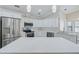Bright kitchen boasts white cabinets, stainless appliances, and an island perfect for food preparation at 6017 Marella Dr, Sarasota, FL 34243
