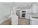 Modern kitchen features white cabinetry, stainless steel appliances, and an island with quartz countertops at 6017 Marella Dr, Sarasota, FL 34243