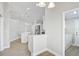 Bright kitchen showcasing stainless steel appliances, white cabinetry, and wood-look tile flooring at 6017 Marella Dr, Sarasota, FL 34243