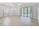 Spacious living room with high ceilings, tile floors, and sliding glass doors leading to the lanai at 6017 Marella Dr, Sarasota, FL 34243