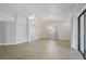 Open-concept living room with vaulted ceilings, tile flooring, recessed lighting, and sliding glass doors at 6017 Marella Dr, Sarasota, FL 34243