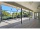 Screened-in back patio overlooking a lake with lush greenery, providing a tranquil outdoor space at 6017 Marella Dr, Sarasota, FL 34243