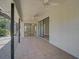 Enclosed back patio area with tiled flooring and sliding glass doors into the home at 6017 Marella Dr, Sarasota, FL 34243