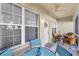 Cozy screened lanai provides a relaxing outdoor space with wicker seating and a serene neighborhood view at 6104 L Pavia Blvd # 6104, Venice, FL 34292