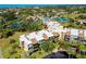 Aerial view of condo buildings, pool, and tennis courts in community at 612 Bird Bay S Dr # 116, Venice, FL 34285