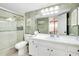 Bathroom featuring a shower with sliding glass doors and a white vanity with ample storage at 612 Bird Bay S Dr # 116, Venice, FL 34285