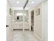 Hallway mirror reflecting dual vanities in a well-lit space at 612 Bird Bay S Dr # 116, Venice, FL 34285