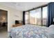 Bedroom featuring a cozy bed with a floral comforter, neutral walls, and bright, natural light at 612 Bird Bay S Dr # 116, Venice, FL 34285