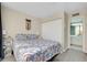 Bright bedroom with a floral bedspread, large closet, and an en-suite bathroom at 612 Bird Bay S Dr # 116, Venice, FL 34285