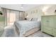 Inviting bedroom with a patterned bedspread, wooden furnishings, and soft natural light at 612 Bird Bay S Dr # 116, Venice, FL 34285