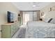 Bright bedroom featuring a light hardwood floor and a large window with blinds at 612 Bird Bay S Dr # 116, Venice, FL 34285