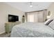 Well-lit bedroom features light hardwood floors, a ceiling fan, and large windows at 612 Bird Bay S Dr # 116, Venice, FL 34285