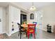 Dining area with colorful chairs, modern flooring, and view to bathroom at 612 Bird Bay S Dr # 116, Venice, FL 34285