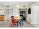 Cozy dining area with a wooden table, colorful chairs and gray laminate flooring at 612 Bird Bay S Dr # 116, Venice, FL 34285