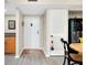 Entryway showcasing a white door, storage cabinet, and wood-style flooring at 612 Bird Bay S Dr # 116, Venice, FL 34285