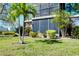 Building exterior showing lawn, garden, and screened in balcony at 612 Bird Bay S Dr # 116, Venice, FL 34285